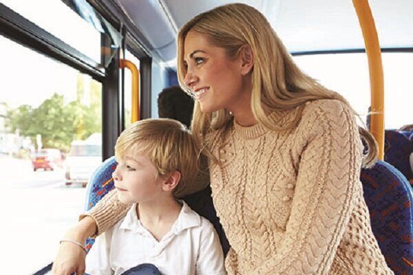 Mother And Son Going To School On Bus Together